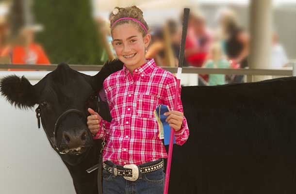 young girl with black cow